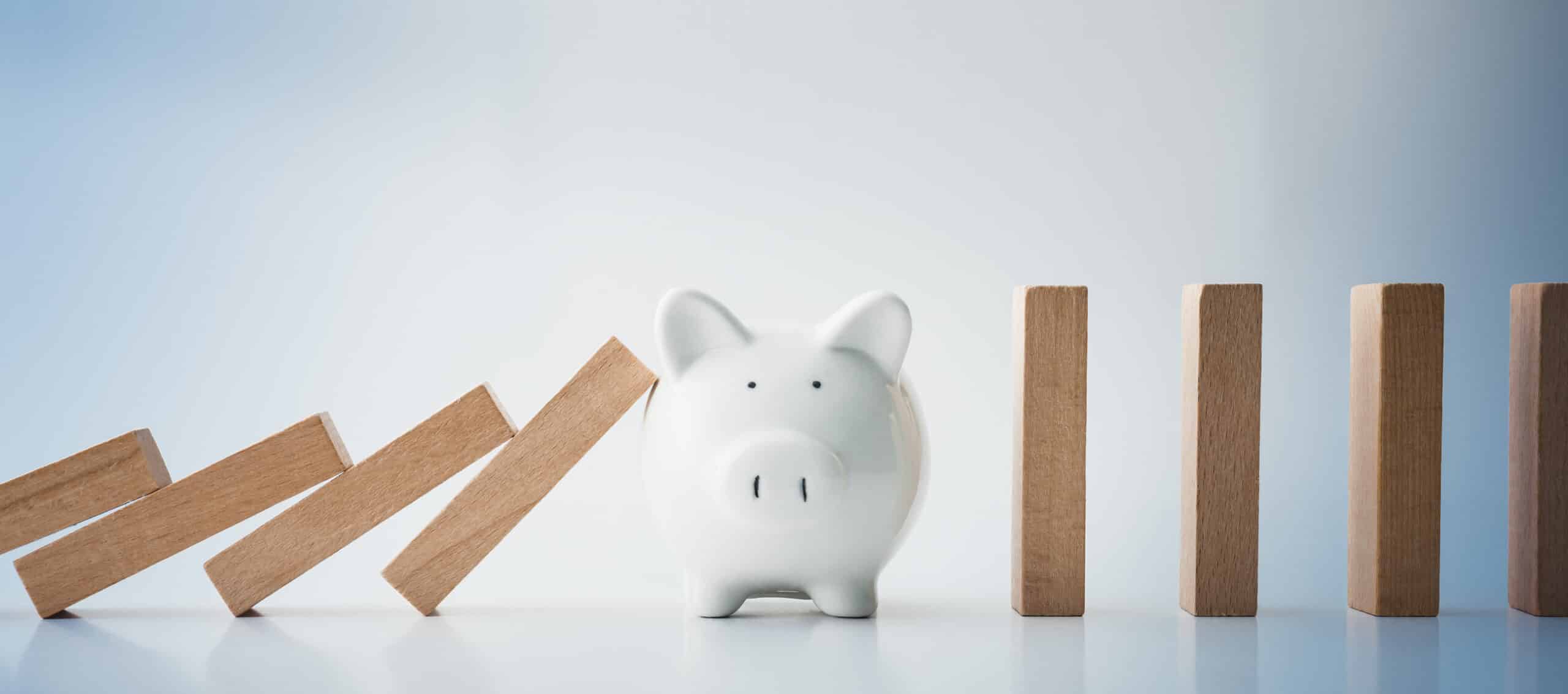 Blocks falling onto piggy bank
